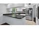 Bright kitchen featuring granite countertops and stainless steel appliances at 35338 Lake Unity Rd, Fruitland Park, FL 34731