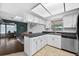 Open concept kitchen with white cabinets, stainless steel appliances, and natural light at 35338 Lake Unity Rd, Fruitland Park, FL 34731