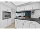 Bright kitchen featuring white cabinetry, black countertops, and stainless steel oven appliances at 35338 Lake Unity Rd, Fruitland Park, FL 34731
