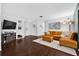 Cozy living room with modern décor, hardwood floors, and a comfortable leather sectional at 35338 Lake Unity Rd, Fruitland Park, FL 34731