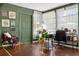 Bright home office with natural light, green walls, and hardwood floors at 35338 Lake Unity Rd, Fruitland Park, FL 34731