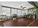 Beautiful sunroom featuring natural light, multiple workstations, and hardwood floors at 35338 Lake Unity Rd, Fruitland Park, FL 34731