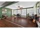 Large sunroom offering versatile space, ample light, and hardwood floors at 35338 Lake Unity Rd, Fruitland Park, FL 34731