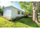 A view of the side of the house with a landscaped flower bed and grassy yard at 36812 Skycrest Blvd, Fruitland Park, FL 34731