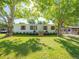 Charming single story home featuring a well-manicured lawn and mature shade trees at 36812 Skycrest Blvd, Fruitland Park, FL 34731