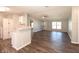 Open-concept living area featuring wood-look floors, neutral paint, and bright natural light at 36812 Skycrest Blvd, Fruitland Park, FL 34731