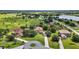 Expansive aerial view showcasing a sprawling estate with lush green landscaping and waterfront views at 36914 Bee Meadow Ct, Eustis, FL 32736