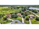 Expansive aerial view showcasing a sprawling estate with lush green landscaping and waterfront views at 36914 Bee Meadow Ct, Eustis, FL 32736
