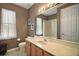 Bathroom featuring a vanity, toilet and tub/shower combination with neutral decor at 36914 Bee Meadow Ct, Eustis, FL 32736