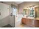 Elegant bathroom featuring a large shower, soaking tub, and double vanity sink at 36914 Bee Meadow Ct, Eustis, FL 32736