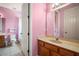 Pink bathroom featuring a vanity with a sink and view of a toilet and shower/tub combination at 36914 Bee Meadow Ct, Eustis, FL 32736