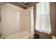 Bathroom with a bathtub/shower combination and a small window providing natural light at 36914 Bee Meadow Ct, Eustis, FL 32736