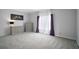 Spacious bedroom featuring neutral carpet, soft gray walls, and large window letting in lots of natural light at 36914 Bee Meadow Ct, Eustis, FL 32736