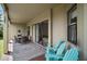 Inviting covered patio with dining table, chairs, and Adirondack chairs, offering ample outdoor seating at 36914 Bee Meadow Ct, Eustis, FL 32736