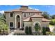 Elegant two-story home featuring a terracotta tile roof and manicured landscaping at 36914 Bee Meadow Ct, Eustis, FL 32736