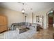Comfortable living room featuring a large grey sectional and stylish decorative rug at 36914 Bee Meadow Ct, Eustis, FL 32736