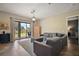 Open living room boasts sliding glass doors to patio and modern furnishings at 36914 Bee Meadow Ct, Eustis, FL 32736