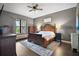 Spacious main bedroom featuring a decorative wood bed frame and ample natural light at 36914 Bee Meadow Ct, Eustis, FL 32736
