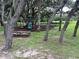 Community playground in a natural setting, surrounded by mature trees and green space for outdoor enjoyment at 36914 Bee Meadow Ct, Eustis, FL 32736