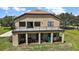Stunning outdoor living space with balcony, covered patio, dining area, and grill at 36914 Bee Meadow Ct, Eustis, FL 32736