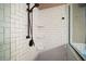 Detailed shot of the shower with white subway tile and bronze fixtures at 36914 Bee Meadow Ct, Eustis, FL 32736