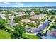 Aerial view of a property surrounded by lush greenery and situated near a serene lake at 418 Rock Springs Cir, Groveland, FL 34736