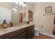 Well-lit bathroom featuring a granite countertop, dark wood cabinets, and neutral-toned walls at 418 Rock Springs Cir, Groveland, FL 34736