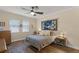 Comfortable bedroom featuring a ceiling fan, two windows, and a serene wolf tapestry at 418 Rock Springs Cir, Groveland, FL 34736