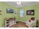 Bright green bedroom with white trim, white arm chair and barn doors on the built in cabinet at 418 Rock Springs Cir, Groveland, FL 34736