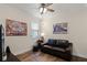 Comfortable bedroom with a leather loveseat, dark wood flooring, and neutral-toned walls at 418 Rock Springs Cir, Groveland, FL 34736