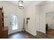 Inviting entryway featuring wood-look tile flooring, coat hooks, and a view into a half-bath at 418 Rock Springs Cir, Groveland, FL 34736