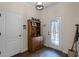 Warm and welcoming entryway with hardwood floors, a decorative hutch, and a stylish glass-paneled door at 418 Rock Springs Cir, Groveland, FL 34736