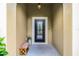 Inviting front entrance with a decorative glass door, covered porch, and a cozy bench at 418 Rock Springs Cir, Groveland, FL 34736