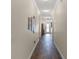 Inviting hallway with elegant wood-look tile flooring and decorative wall art at 418 Rock Springs Cir, Groveland, FL 34736