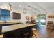 Eat-in kitchen featuring granite countertops, a center island, and sliding glass doors to the outside patio at 418 Rock Springs Cir, Groveland, FL 34736