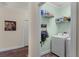Functional laundry room featuring a modern washing machine, shelving, and storage at 418 Rock Springs Cir, Groveland, FL 34736