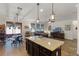 Open-concept living room with a kitchen island, dining area, and a comfortable seating area with a ceiling fan at 418 Rock Springs Cir, Groveland, FL 34736