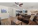 Inviting living room open to the kitchen, featuring a large sofa and modern decor at 418 Rock Springs Cir, Groveland, FL 34736