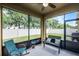Covered porch with furniture, a ceiling fan, and views of the fenced backyard at 418 Rock Springs Cir, Groveland, FL 34736