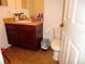 Standard bathroom featuring a vanity with cabinet storage, and a toilet with linoleum flooring at 5016 Mcdonald Rd, Zellwood, FL 32798