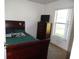 Standard bedroom featuring dark wood furnishings, and a window letting in lots of light at 5016 Mcdonald Rd, Zellwood, FL 32798