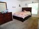 Cozy bedroom with a dresser and carpet flooring at 5016 Mcdonald Rd, Zellwood, FL 32798