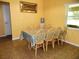 Bright dining area featuring a large window and neutral wall color at 5016 Mcdonald Rd, Zellwood, FL 32798