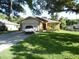 Charming single-story home boasts a well-manicured lawn and inviting curb appeal at 5016 Mcdonald Rd, Zellwood, FL 32798