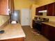 Well-lit eat-in kitchen with wood cabinets and tile flooring at 5016 Mcdonald Rd, Zellwood, FL 32798