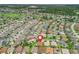 Aerial view of a residential neighborhood with well-manicured lawns, mature trees, and proximity to a golf course at 591 Allenwood Loop, The Villages, FL 32162