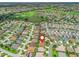 Aerial view showcases a golf course community with houses and a scenic lake at 591 Allenwood Loop, The Villages, FL 32162