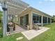 Covered back patio perfect for outdoor entertaining with screened enclosure and access to the backyard at 591 Allenwood Loop, The Villages, FL 32162