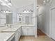 Bright bathroom featuring a granite countertop, double sinks, and neutral tile flooring at 591 Allenwood Loop, The Villages, FL 32162