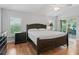 Spacious bedroom with dark wood furniture and hardwood floors at 591 Allenwood Loop, The Villages, FL 32162